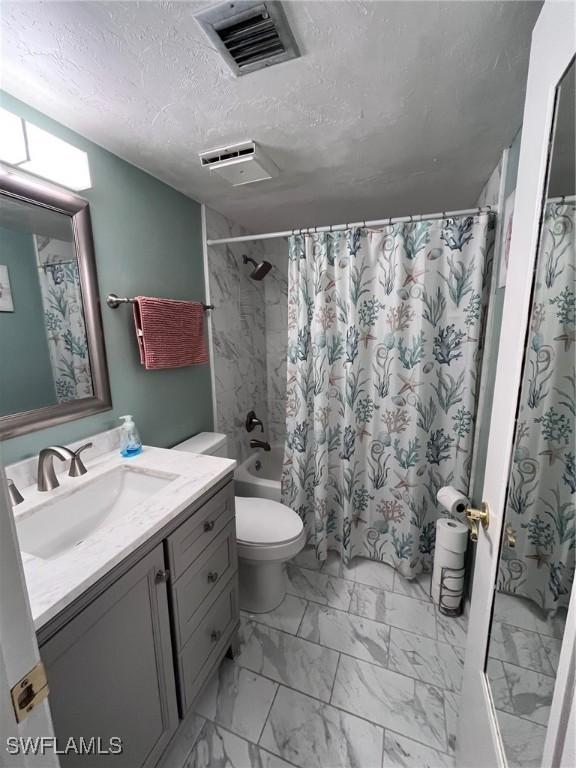 full bath with marble finish floor, visible vents, toilet, a textured ceiling, and vanity