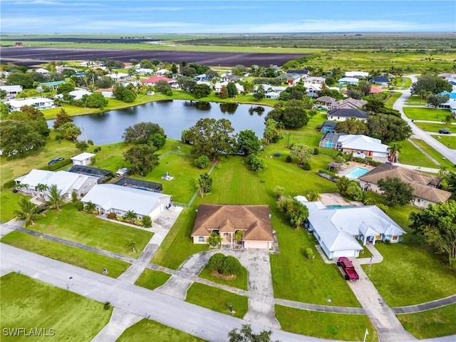 bird's eye view featuring a water view and a residential view