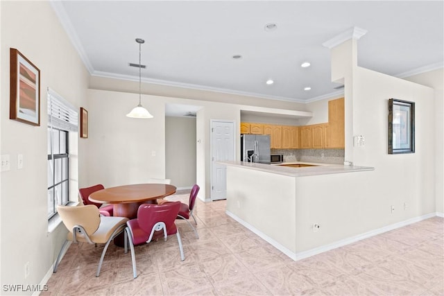 kitchen with plenty of natural light, tasteful backsplash, ornamental molding, and stainless steel appliances