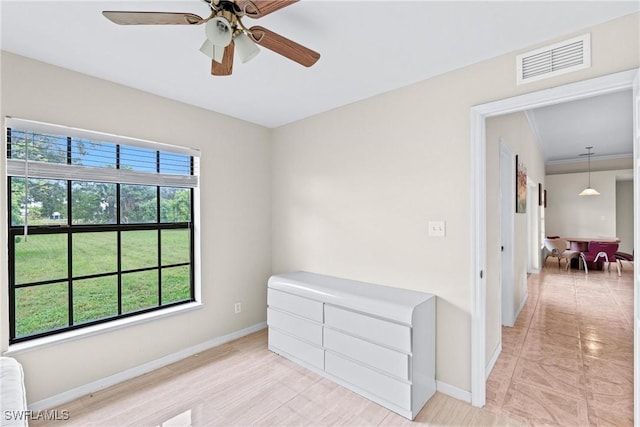 unfurnished room featuring ceiling fan, radiator, visible vents, and baseboards