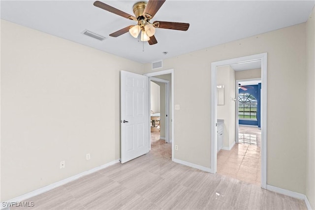 unfurnished bedroom with a ceiling fan, visible vents, and baseboards