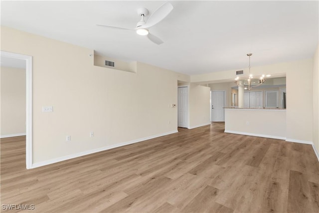 unfurnished living room with light wood-type flooring, visible vents, baseboards, and ceiling fan with notable chandelier