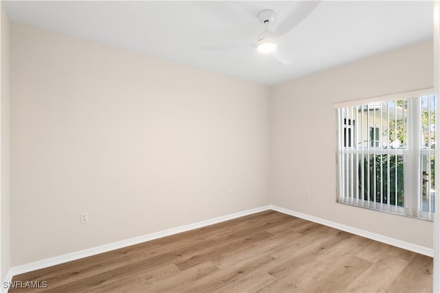 unfurnished room with light wood-type flooring, a ceiling fan, and baseboards