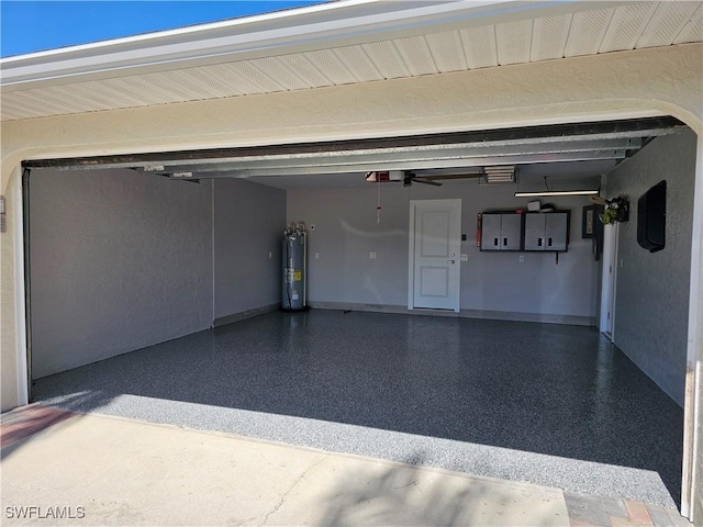 6048 Birnam Wood Ln, Fort Myers, FL 33908 - garage featuring baseboards, a ceiling fan, and electric water heater