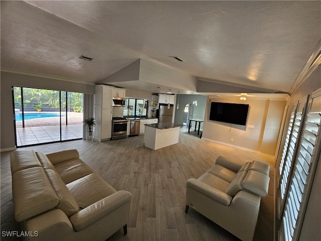 6048 Birnam Wood Ln, Fort Myers, FL 33908 - living room featuring lofted ceiling, visible vents, crown molding, and light wood finished floors
