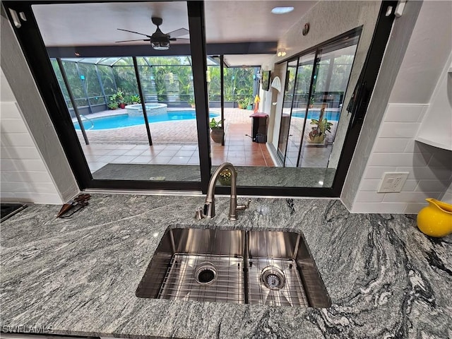 6048 Birnam Wood Ln, Fort Myers, FL 33908 - details with stone countertops, a sink, a pool, and a ceiling fan