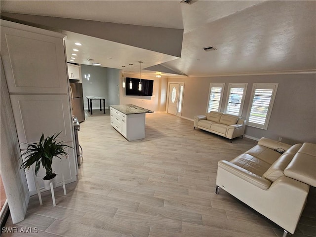 6048 Birnam Wood Ln, Fort Myers, FL 33908 - living area featuring crown molding, light wood finished floors, visible vents, vaulted ceiling, and baseboards