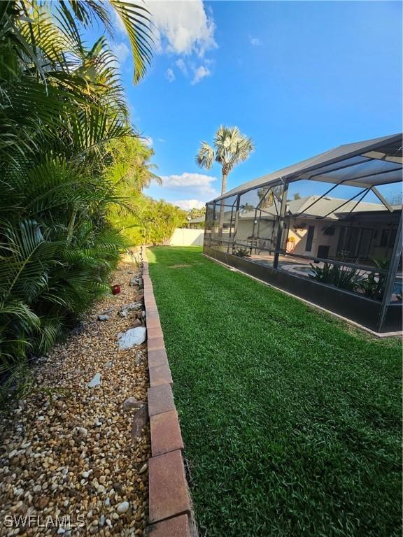 6048 Birnam Wood Ln, Fort Myers, FL 33908 - view of yard with a lanai and fence