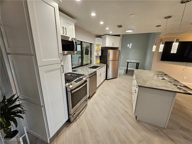 6048 Birnam Wood Ln, Fort Myers, FL 33908 - kitchen with appliances with stainless steel finishes, white cabinets, a sink, and light wood-style flooring