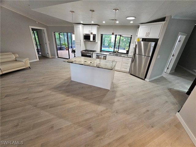 6048 Birnam Wood Ln, Fort Myers, FL 33908 - kitchen featuring light wood-style floors, a kitchen island, stainless steel appliances, and a wealth of natural light