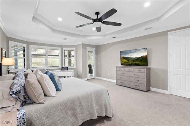 bedroom featuring a tray ceiling, light carpet, visible vents, and baseboards