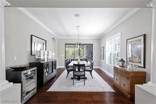 dining area with ornate columns, ornamental molding, and dark wood-type flooring