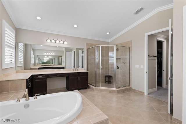 bathroom featuring a bath, ornamental molding, a stall shower, and visible vents