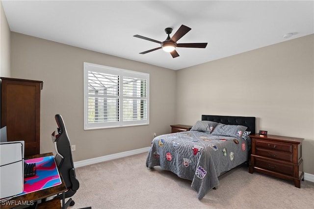 bedroom with light carpet, ceiling fan, and baseboards