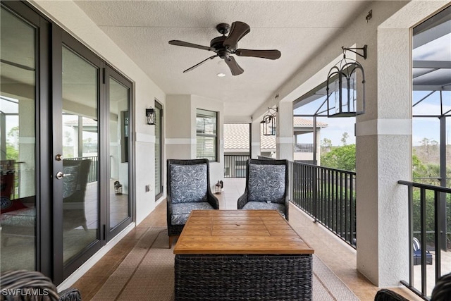 sunroom / solarium featuring a wealth of natural light and a ceiling fan