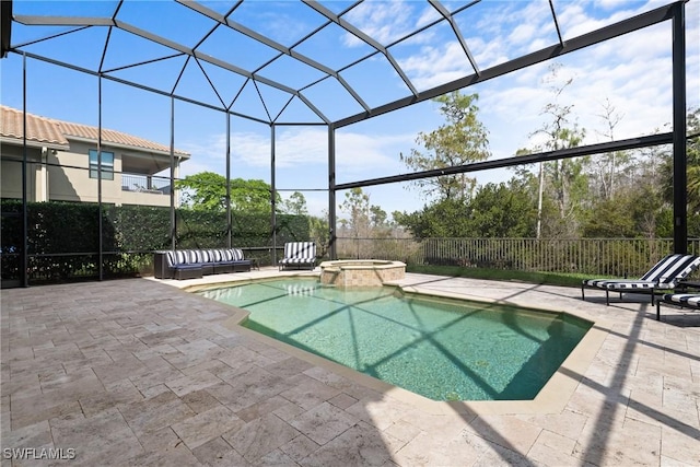 view of swimming pool featuring a pool with connected hot tub, glass enclosure, a patio, and fence