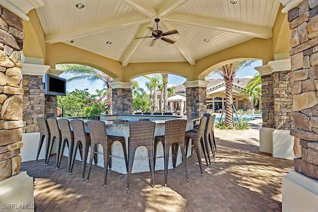 view of patio / terrace featuring ceiling fan, outdoor dry bar, and a gazebo