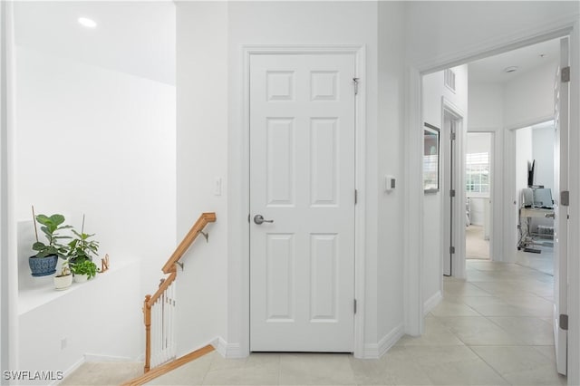 43333 Water Bird Way Unit 4821, Punta Gorda, FL 33982 - hallway featuring baseboards, light tile patterned flooring, and an upstairs landing