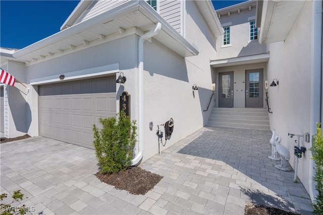 garage featuring decorative driveway