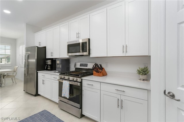 43333 Water Bird Way Unit 4821, Punta Gorda, FL 33982 - kitchen featuring stainless steel appliances, white cabinetry, light countertops, light tile patterned floors, and recessed lighting