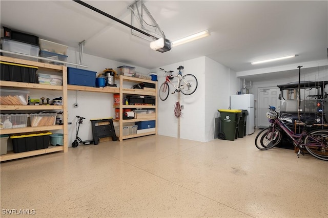 43333 Water Bird Way Unit 4821, Punta Gorda, FL 33982 - garage featuring freestanding refrigerator and a garage door opener