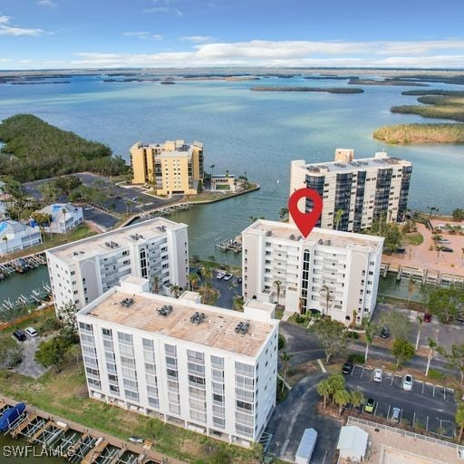 birds eye view of property with a water view and a view of city