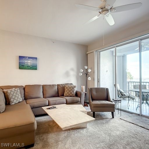 carpeted living room featuring a ceiling fan