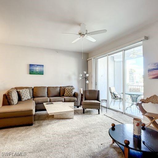 carpeted living room with a ceiling fan