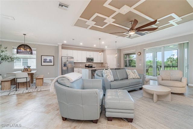 living room featuring light tile patterned floors, visible vents, crown molding, and baseboards