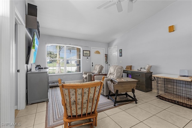 living room with lofted ceiling, a ceiling fan, and light tile patterned flooring