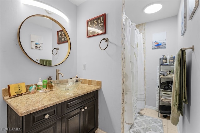 full bath featuring a shower with shower curtain, tile patterned flooring, and vanity