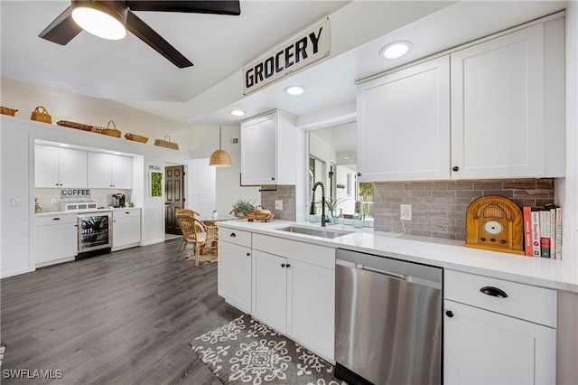 kitchen with stainless steel dishwasher, wine cooler, a sink, and white cabinets