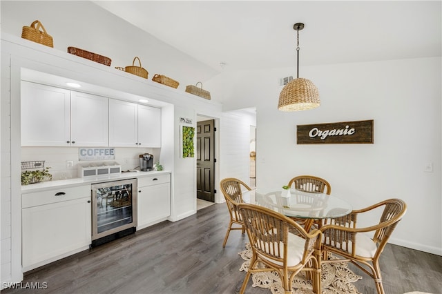 kitchen with beverage cooler, visible vents, white cabinets, dark wood-type flooring, and light countertops