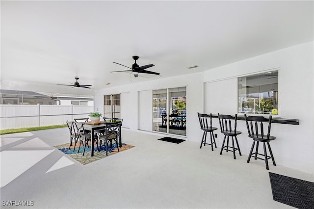 view of patio / terrace with outdoor dining area, visible vents, ceiling fan, and fence