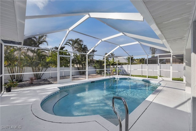 view of swimming pool featuring a fenced in pool, glass enclosure, a fenced backyard, and a patio