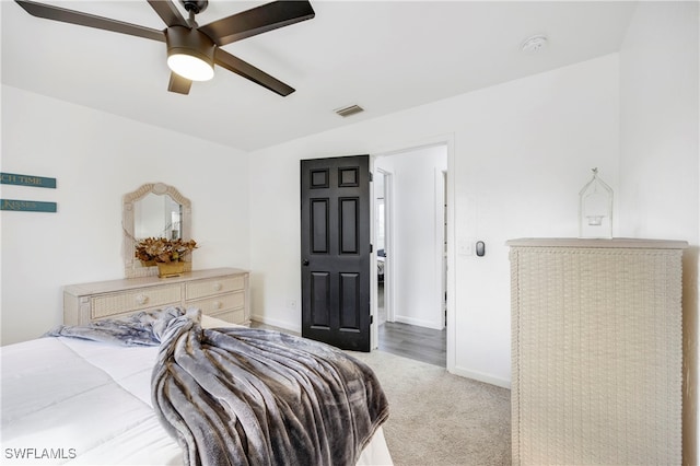 carpeted bedroom featuring ceiling fan and baseboards