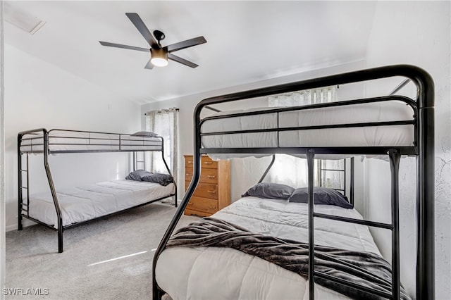 bedroom with vaulted ceiling, carpet floors, and ceiling fan