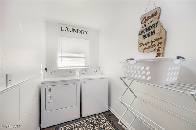 washroom featuring laundry area, a wainscoted wall, dark wood-style flooring, and washing machine and clothes dryer