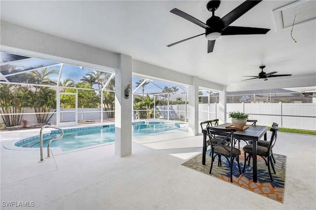 view of swimming pool featuring a fenced in pool, a patio, glass enclosure, ceiling fan, and a fenced backyard