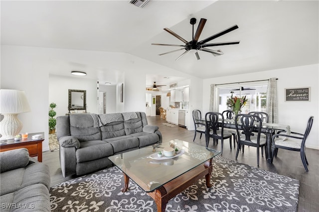 living area featuring lofted ceiling, visible vents, ceiling fan, and wood finished floors