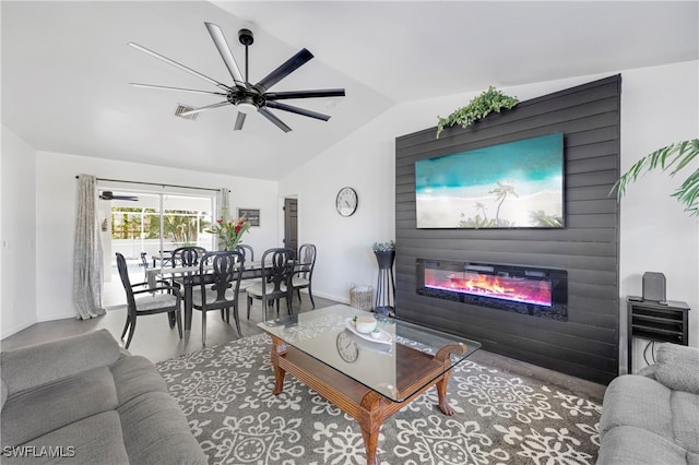 living area featuring a glass covered fireplace, vaulted ceiling, baseboards, and ceiling fan