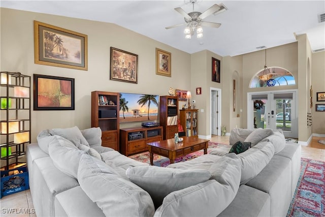 living area with baseboards, visible vents, vaulted ceiling, and french doors