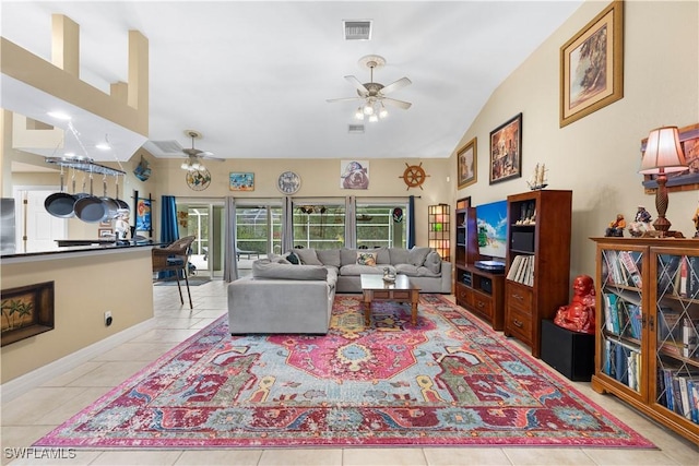 tiled living area featuring ceiling fan, visible vents, vaulted ceiling, and baseboards