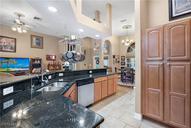 kitchen featuring arched walkways, visible vents, a sink, dishwasher, and ceiling fan with notable chandelier