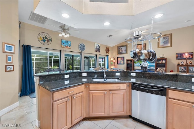 kitchen with light tile patterned floors, visible vents, a sink, dark stone counters, and dishwasher