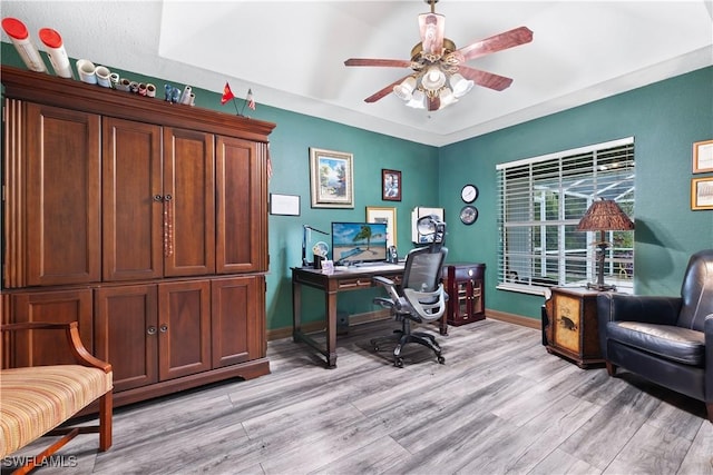 office with light wood-type flooring, baseboards, and a ceiling fan