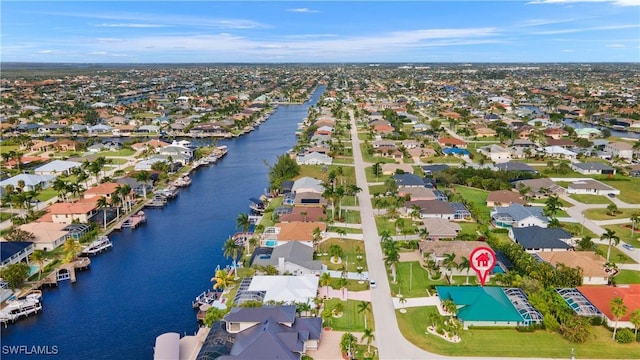 drone / aerial view with a residential view and a water view