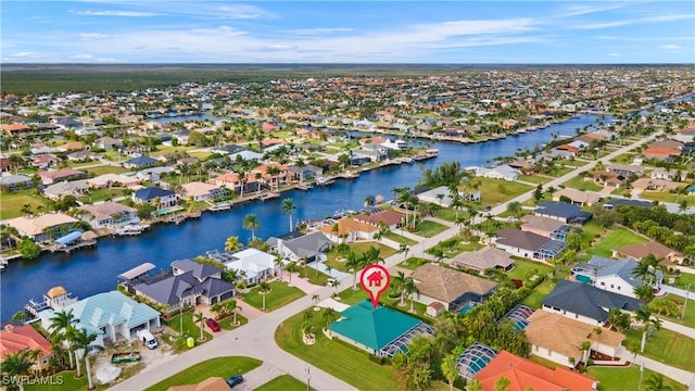 drone / aerial view featuring a water view and a residential view