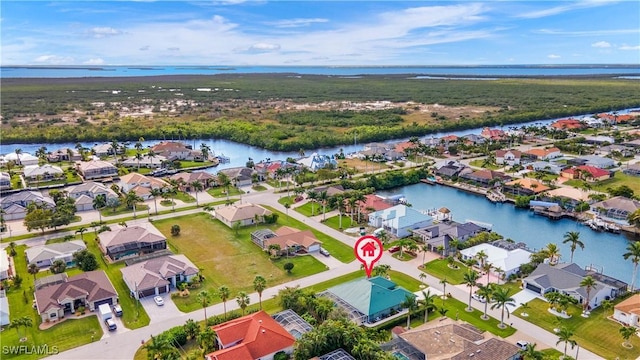 drone / aerial view featuring a water view and a residential view