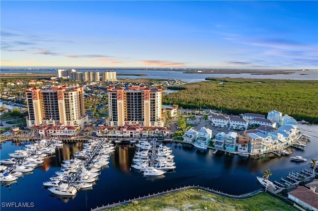 aerial view at dusk with a view of city and a water view